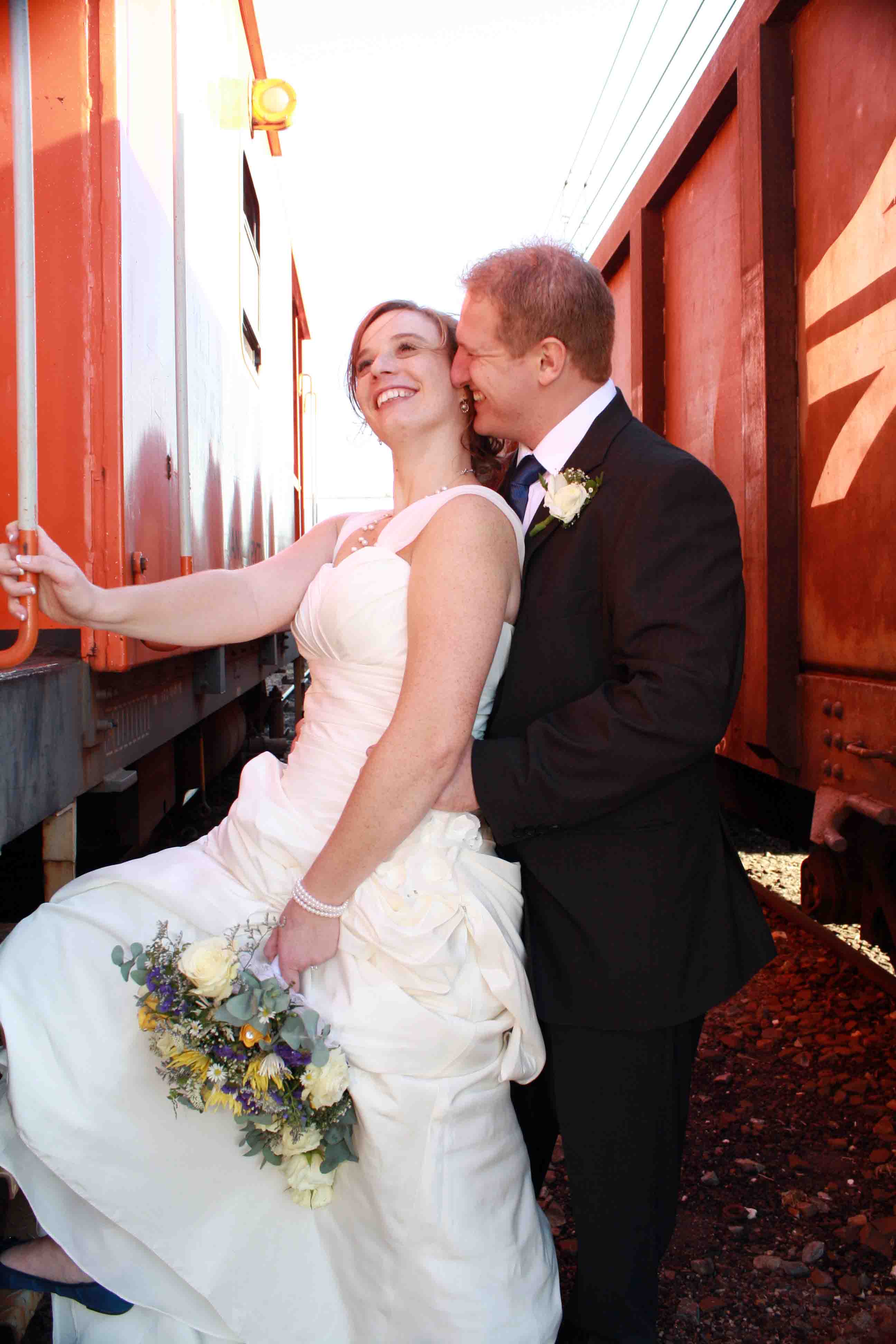 The Bride and Groom in between the trains